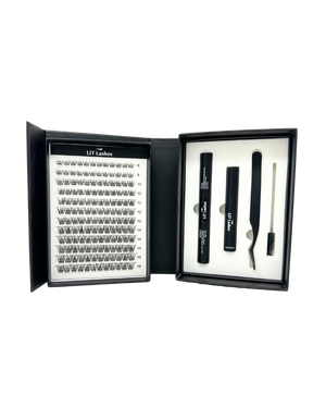 Eyelash extension kit with lashes, glue, and tools in a black box on a white background