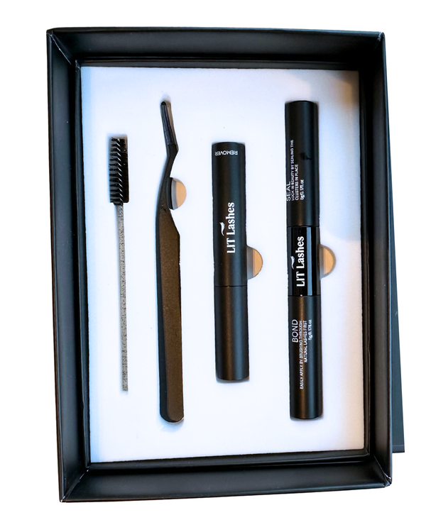 Set of eyebrow grooming tools including a brush, razor, and two black containers in a black box.